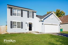 Plainfield house for rent - a white house with a white garage door and a lawn