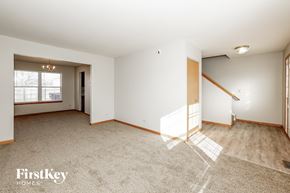 Plainfield house for rent - a living room with white walls and wood flooring and a staircase