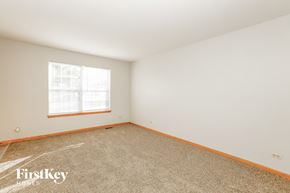 Plainfield house for rent - a bedroom with white walls and carpet and a window