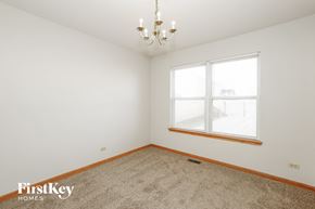 Plainfield house for rent - a bedroom with a large window and a carpet
