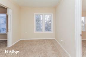 Zion house for rent - a bedroom with a carpeted floor and a window