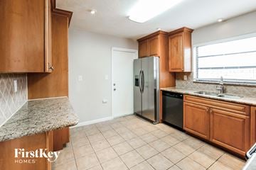Cutler Bay house for rent - a kitchen with wooden cabinets and a stainless steel refrigerator
