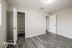Cutler Bay house for rent - a bedroom with white walls and a closet and wood flooring