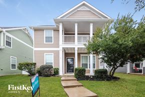 Aubrey house for rent - a home with a flag in front of it on a lawn
