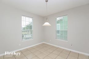 Aubrey house for rent - an empty dining room with a pendant light and tiled floor