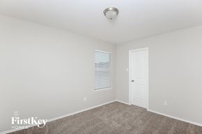 Aubrey house for rent - a bedroom with white walls and carpet and a white door