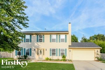 Noblesville house for rent - a white house with blue shutters and a lawn