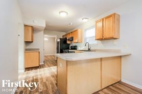 Noblesville house for rent - a kitchen with wooden cabinets and a counter top in a house