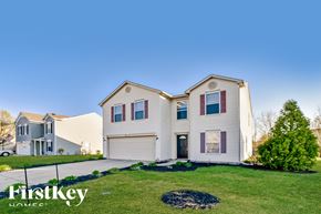 Greenfield house for rent - A large, two-story house with a garage is showcased in the image.