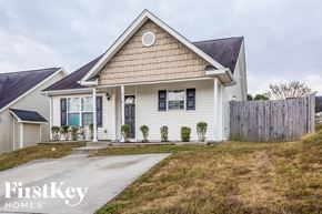 Kannapolis house for rent - a white house with a yard and a wooden fence