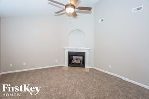 Kannapolis house for rent - the living room has a fireplace and a ceiling fan