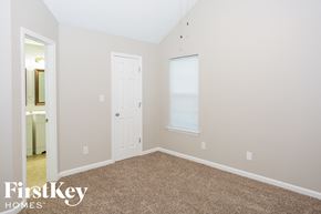 Kannapolis house for rent - a bedroom with a carpeted floor and a white door