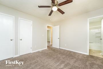 Lithonia house for rent - a living room with carpet and a ceiling fan