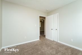Lithonia house for rent - a bedroom with white walls and carpet and a door to a hallway