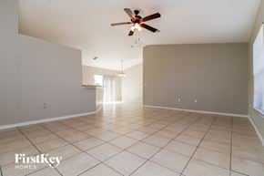 Cape Coral house for rent - A spacious room with a ceiling fan and tiled flooring.