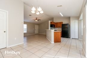 Cape Coral house for rent - A kitchen with a white tile floor and a wooden island.
