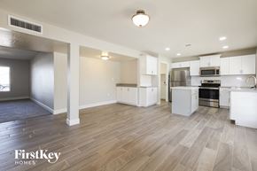 Phoenix house for rent - A spacious kitchen with white appliances and wooden flooring.