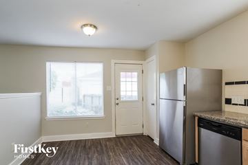 Humble house for rent - A kitchen with a refrigerator and a dishwasher.