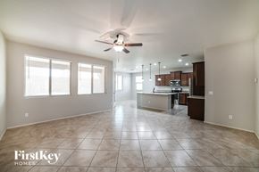 San Tan Valley house for rent - an empty kitchen and living room with a ceiling fan