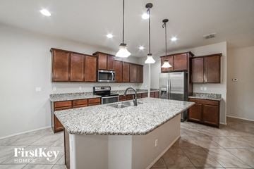 San Tan Valley house for rent - a kitchen with granite counter tops and wooden cabinets