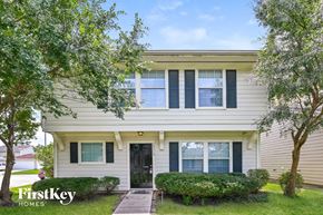 Houston house for rent - A house with a black front door and a small porch.