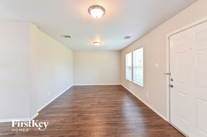 Houston house for rent - A room with wooden floors and a white door.