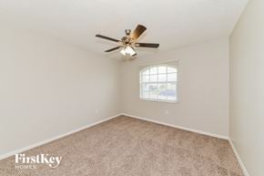 North Port house for rent - a bedroom with carpet and a ceiling fan