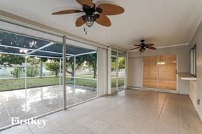 Cape Coral house for rent - a living room with a ceiling fan and a sliding glass door