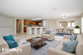 Poinciana house for rent - A living room with a couch, chairs, and a coffee table.