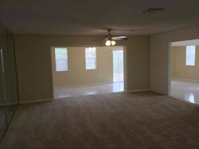 Miami Gardens house for rent - an empty living room with a ceiling fan