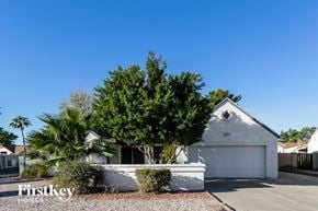 Phoenix house for rent - a white garage with a tree in front of it