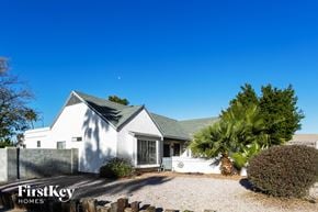 Phoenix house for rent - a small white house with a palm tree in front of it