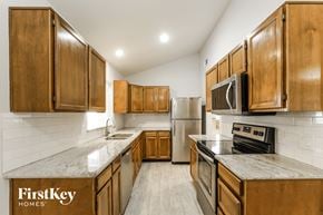 Phoenix house for rent - a kitchen with wooden cabinets and stainless steel appliances