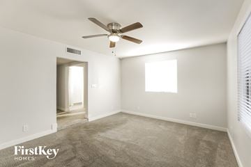 Phoenix house for rent - a living room with carpet and a ceiling fan