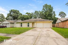 Humble house for rent - a small white house with a driveway and a brick building