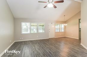 Humble house for rent - the living room of an empty house with a ceiling fan