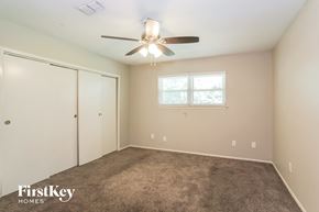 Humble house for rent - a bedroom with carpet and a ceiling fan and a closet
