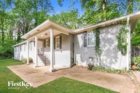 Smyrna house for rent - A white house with a porch and a staircase leading to the front door.