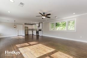 Smyrna house for rent - A spacious room with wooden flooring and a ceiling fan.