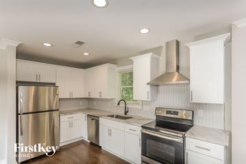 Smyrna house for rent - A kitchen with white cabinets and a stainless steel refrigerator.