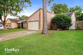 Cypress house for rent - a house with a yard and a tree in front of it
