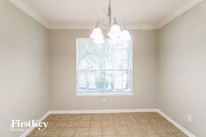 Katy house for rent - a dining room with a large window and a tiled floor