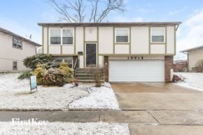 Lynwood house for rent - a cream colored house with white snow on the ground