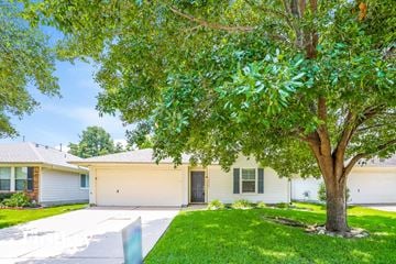 Cypress house for rent - a white house with a tree in front of it