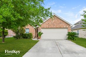 Humble house for rent - a white garage door in front of a brick house