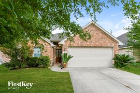 Humble house for rent - a brick house with a white garage door