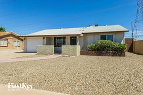 Chandler house for rent - a home with a gravel driveway and a white house
