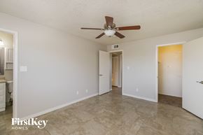 Chandler house for rent - a living room with a ceiling fan and a door to a bathroom