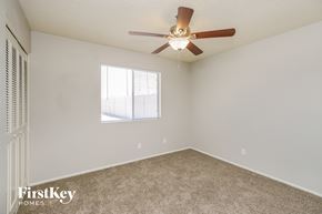 Chandler house for rent - a bedroom with a ceiling fan and a window
