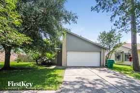 Humble house for rent - a garage with a white garage door and a driveway